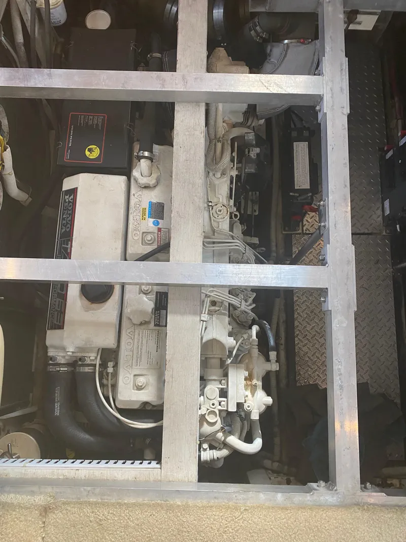 Slide: The Image of Engine compartment of a 2002 Carver 444 Cockpit Motor Yacht, showcasing mechanical components. - 22