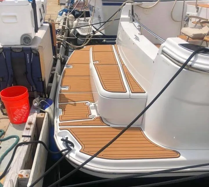 Slide: The Image of 2002 Carver 444 Cockpit Motor Yacht docked with teak-style decking. - 24