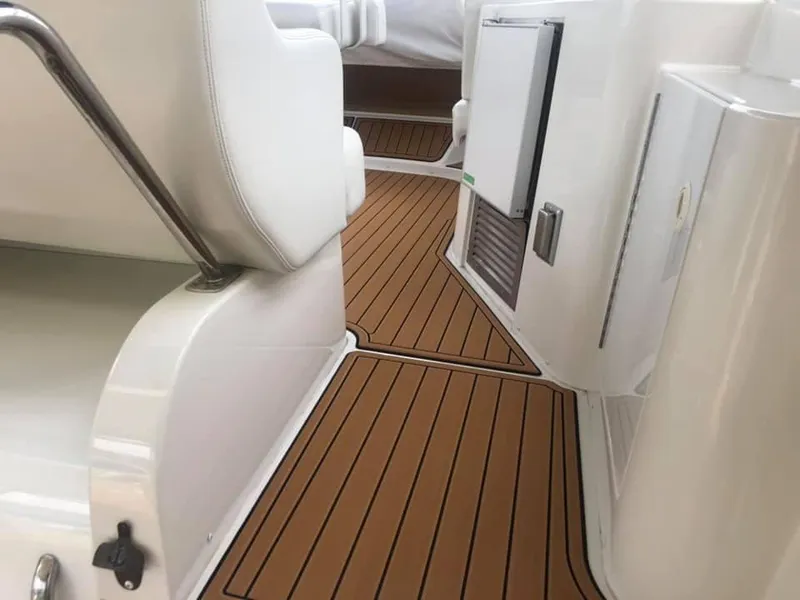 Slide: The Image of 2002 Carver 444 Cockpit Motor Yacht interior with teak flooring and white seating. - 7