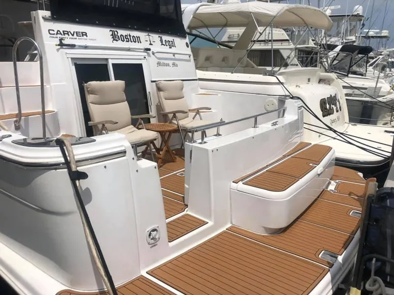 Slide: The Image of 2002 Carver 444 Cockpit Motor Yacht with teak deck and seating area. - 16