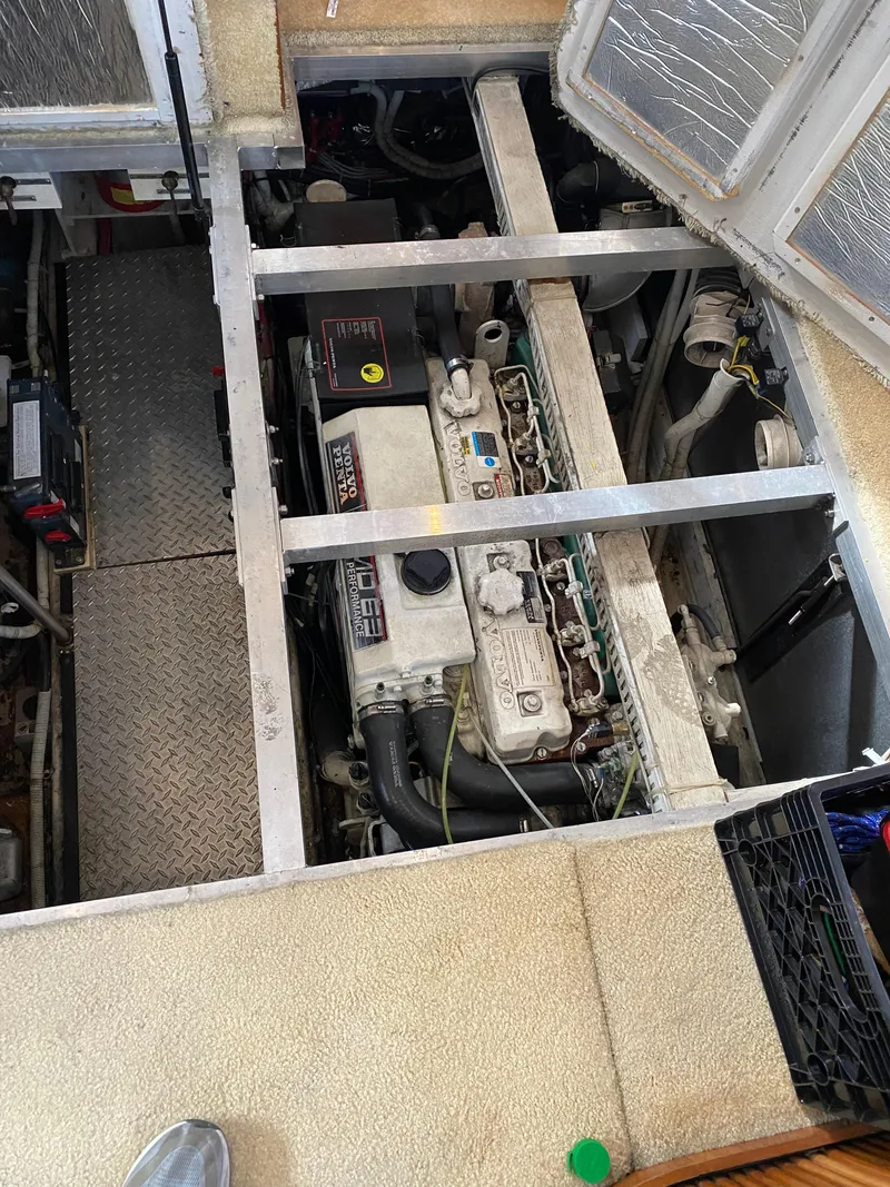 Slide: The Image of Engine compartment of a 2002 Carver 444 Cockpit Motor Yacht, showing mechanical components. - 23