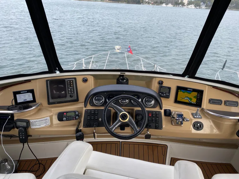 Slide: The Image of 2002 Carver 444 Cockpit Motor Yacht helm with navigation equipment and steering wheel. - 5