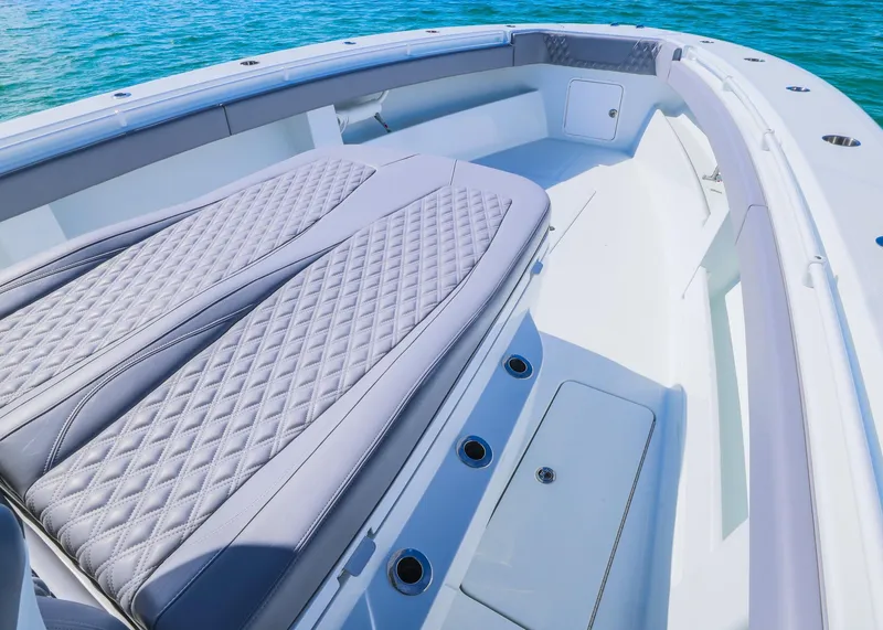 Slide: The Image of 2025 Invincible 39 Open Fisherman boat interior with luxurious seating and ocean backdrop. - 10