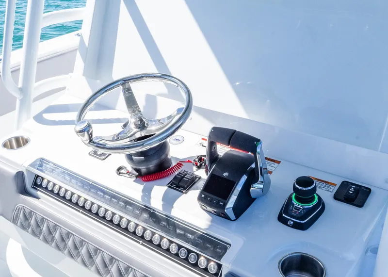 Slide: The Image of Helm of 2025 Invincible 39 Open Fisherman with steering wheel and controls. - 11