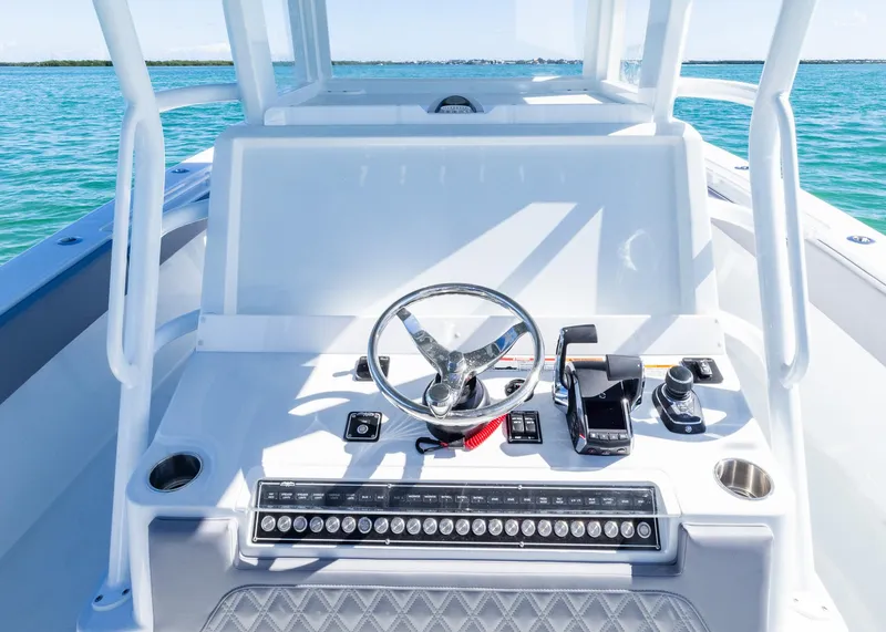 Slide: The Image of 2025 Invincible 39 Open Fisherman boat dashboard with steering wheel and controls. - 12
