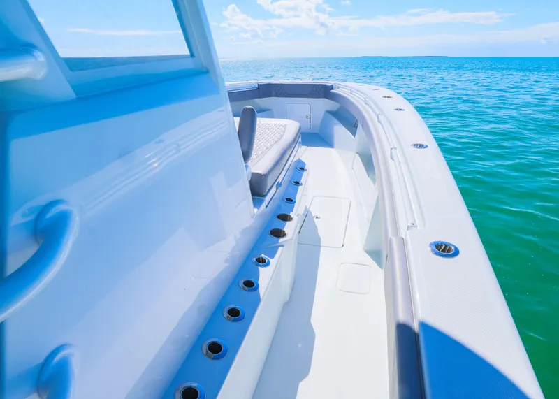 Slide: The Image of 2025 Invincible 39 Open Fisherman boat on clear blue water. - 16