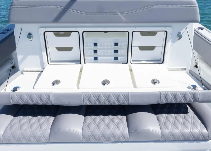 Slide: The Image of 2025 Invincible 39 Open Fisherman boat with cushioned seating and storage compartments. - 17
