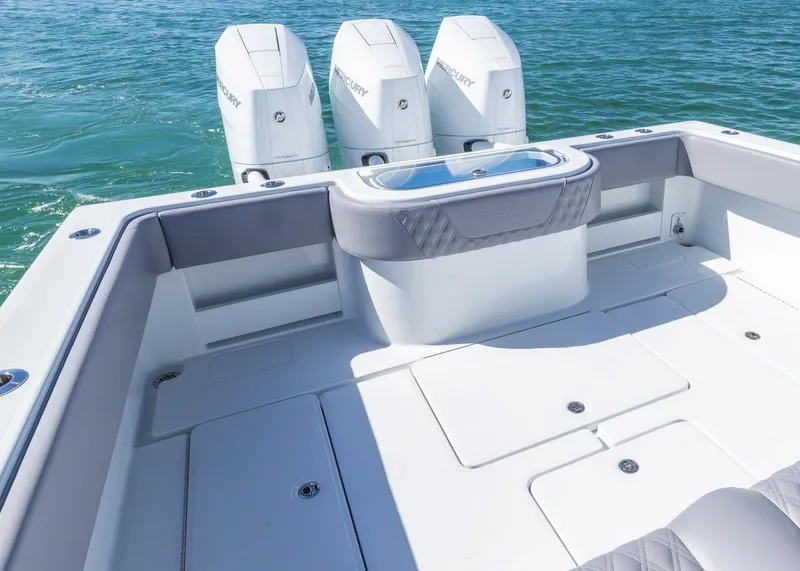 Slide: The Image of 2025 Invincible 39 Open Fisherman boat with triple outboard engines on clear water. - 18