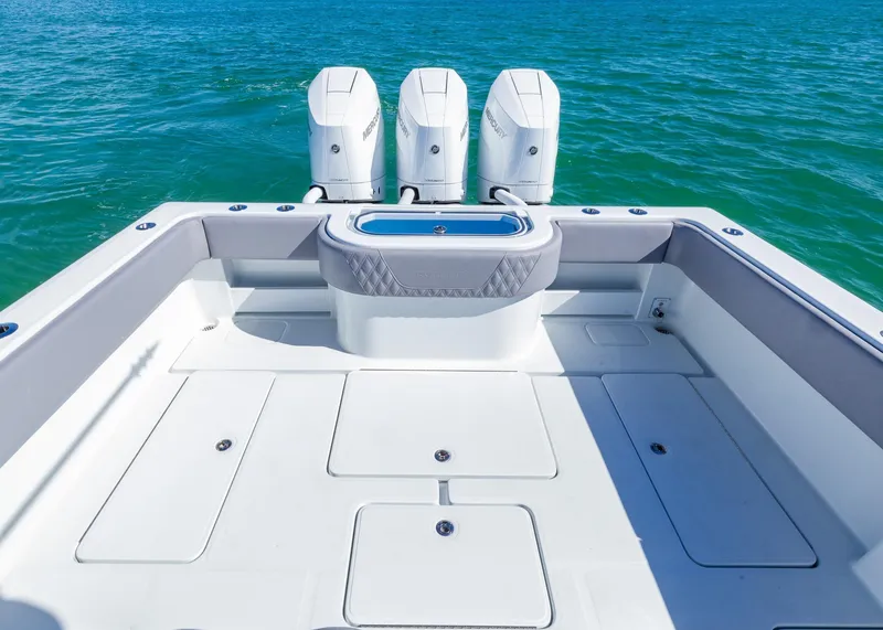 Slide: The Image of 2025 Invincible 39 Open Fisherman boat with triple engines on blue water. - 21