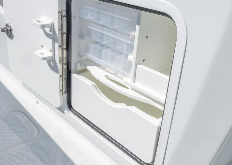 Slide: The Image of Storage compartment on 2025 Invincible 39 Open Fisherman boat, featuring organized shelves and drawers. - 24