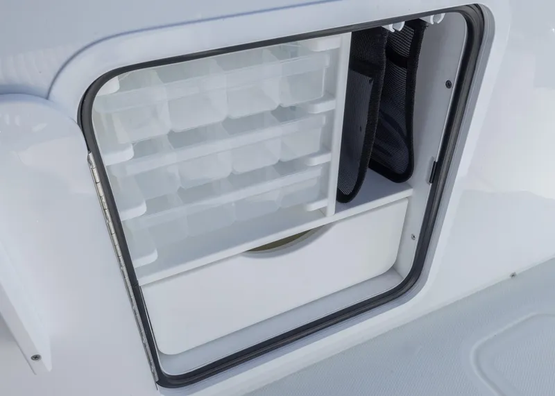 Slide: The Image of Storage compartment on 2025 Invincible 39 Open Fisherman boat, featuring organized tackle boxes. - 25