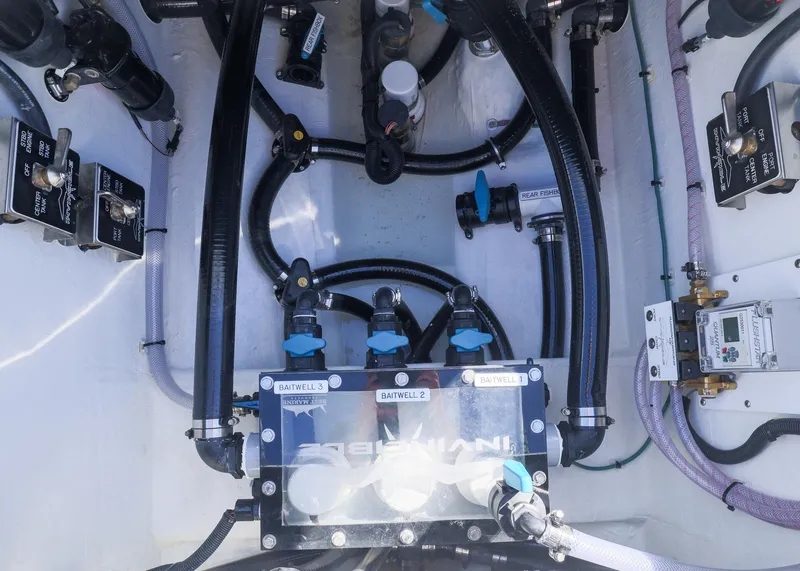 Slide: The Image of Engine compartment of 2025 Invincible 39 Open Fisherman with visible hoses and valves. - 32
