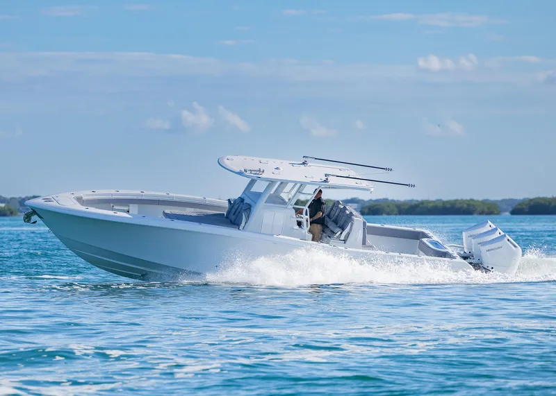 Slide: The Image of 2025 Invincible 39 Open Fisherman boat cruising on clear blue water. - 40