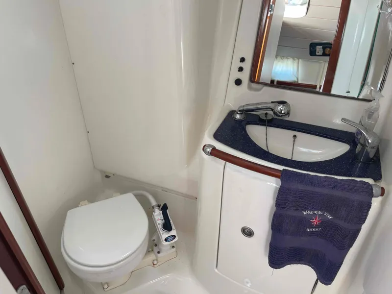 Slide: The Image of Beneteau Oceanis 473 2004 yacht bathroom with sink, mirror, and toilet. - 10
