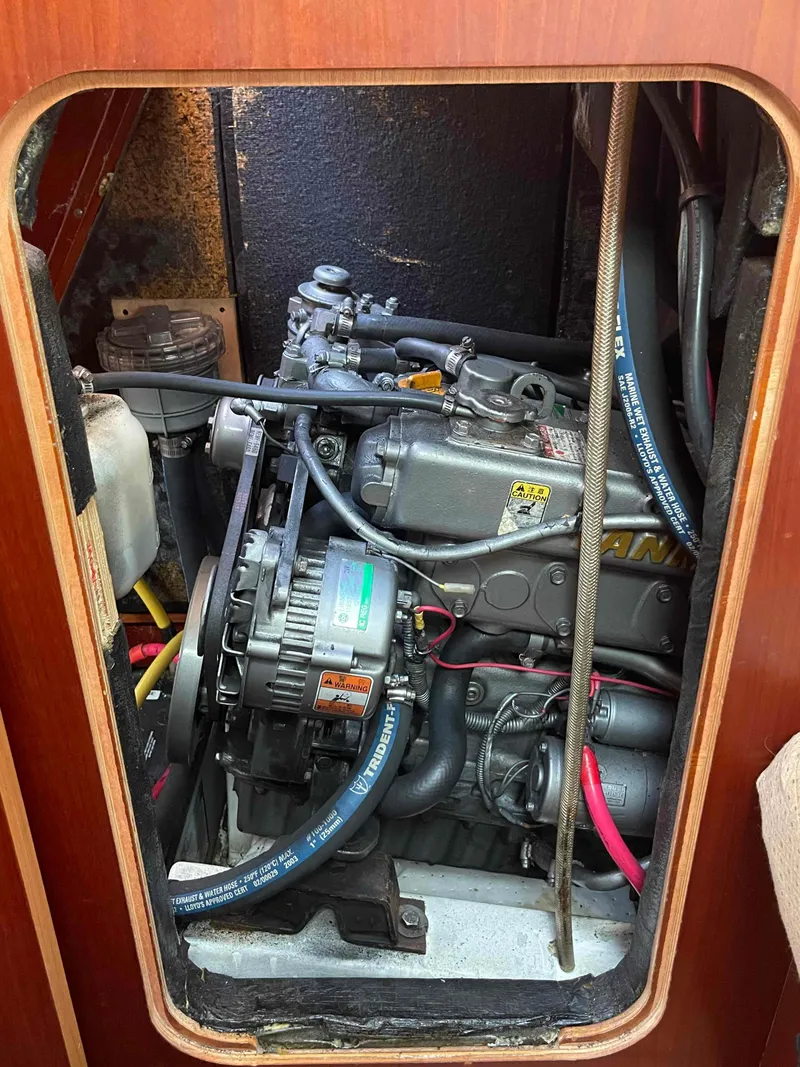 Slide: The Image of Engine compartment of a 2004 Beneteau Oceanis 473 sailboat, showcasing mechanical components. - 11