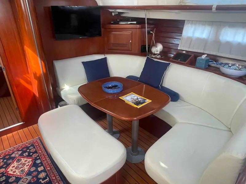 Slide: The Image of Luxurious interior of 2004 Beneteau Oceanis 473 yacht with elegant seating and wooden finishes. - 13