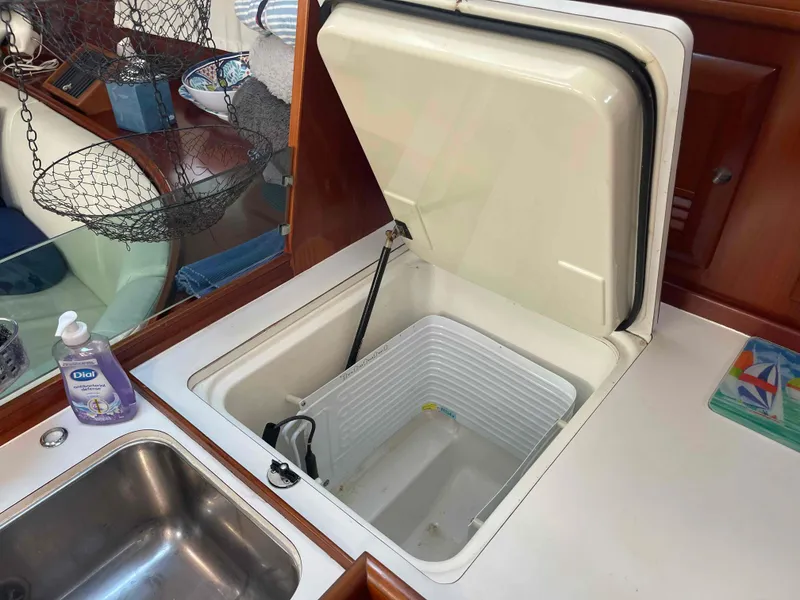 Slide: The Image of Open fridge in 2004 Beneteau Oceanis 473 yacht kitchen, with sink and countertop. - 22