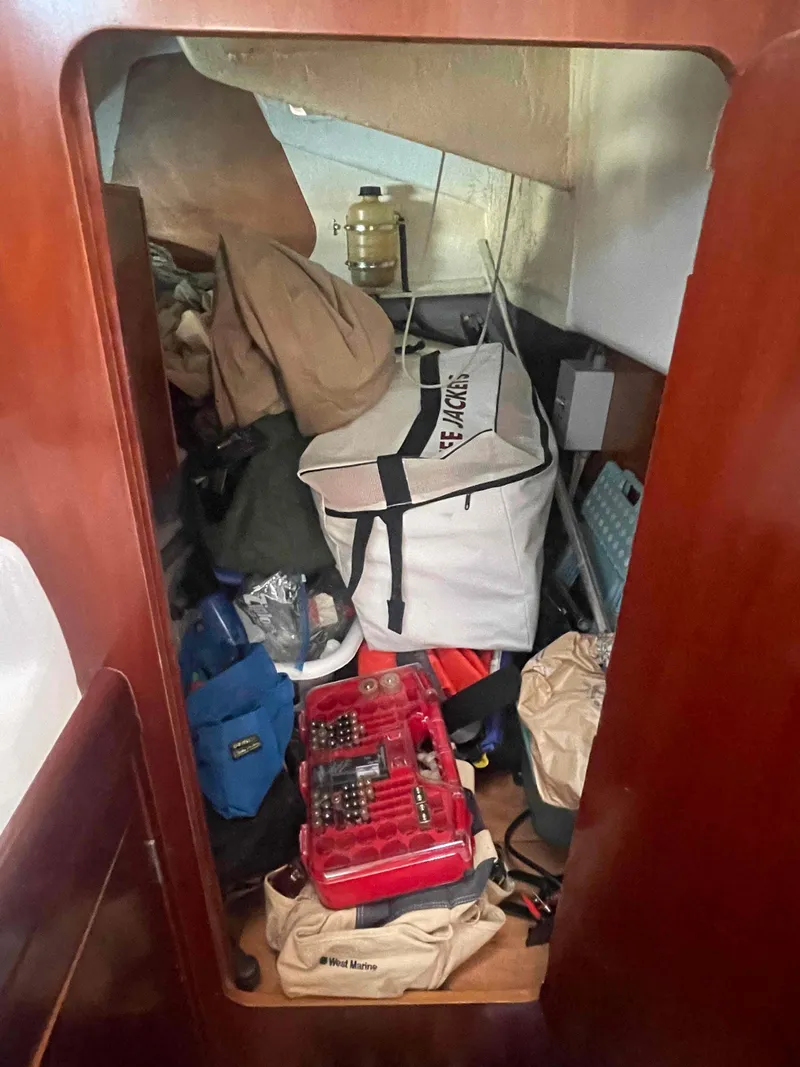 Slide: The Image of Cluttered storage area inside a 2004 Beneteau Oceanis 473 sailboat. - 25