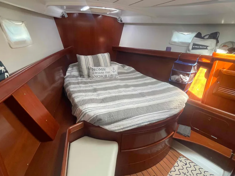 Slide: The Image of Cozy cabin interior of 2004 Beneteau Oceanis 473 sailboat with striped bedding. - 7