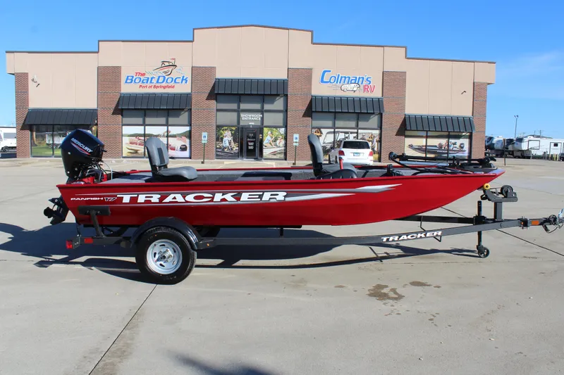 The Image of 2025 Tracker Panfish 17 boat in red, parked outside a dealership. - 1