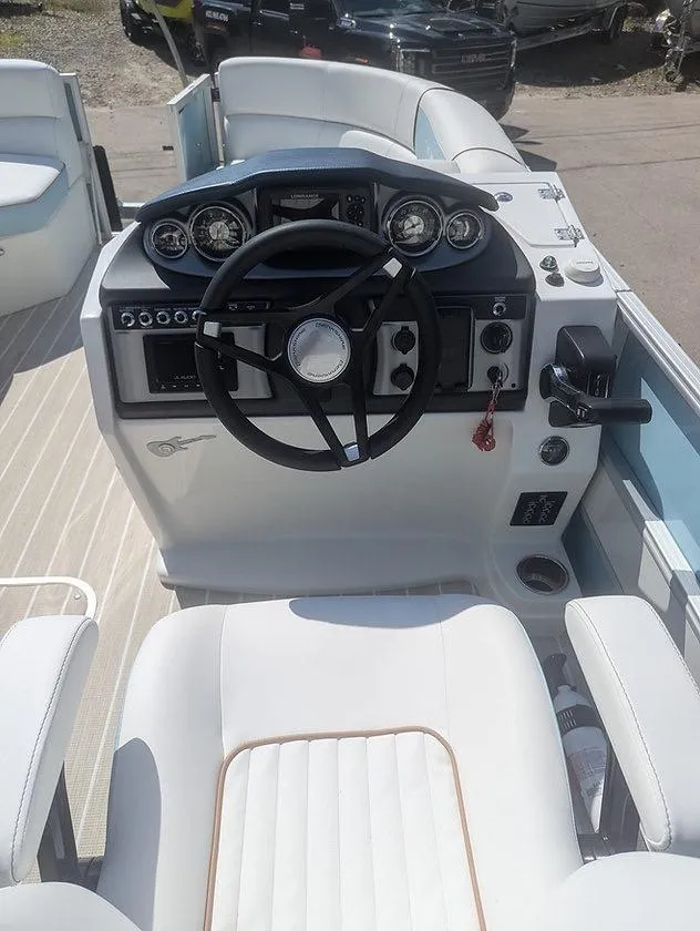 Slide: The Image of 2025 Berkshire 22E CTS boat dashboard with steering wheel and controls. - 3