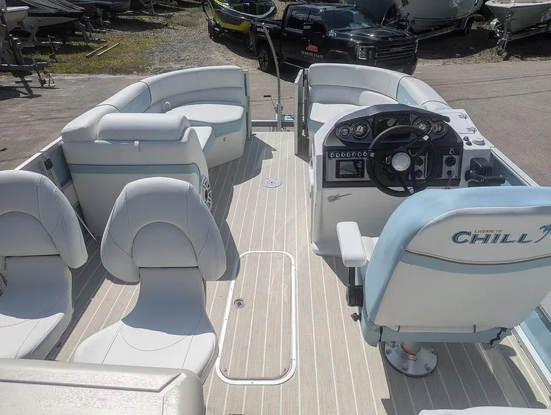 Slide: The Image of 2025 Berkshire 22E CTS boat interior with white seating and modern dashboard. - 5