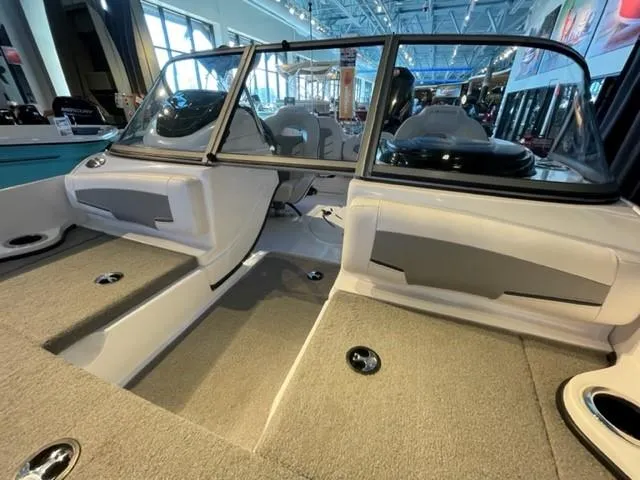 Slide: The Image of 2019 Nitro Z19 Sport boat interior with carpeted deck and seating. - 10