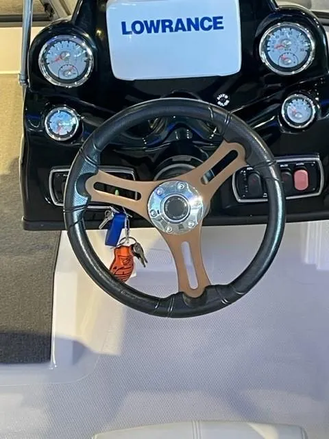 Slide: The Image of Steering wheel and dashboard of 2019 Nitro Z19 Sport boat with Lowrance display. - 11