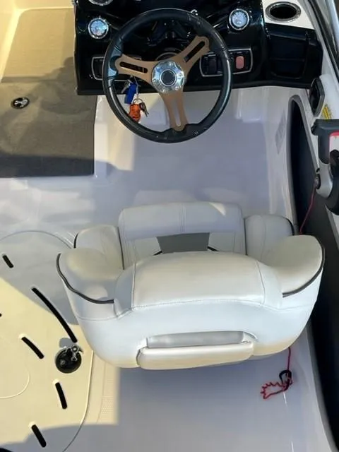 Slide: The Image of 2019 Nitro Z19 Sport boat interior with steering wheel and white seat. - 6