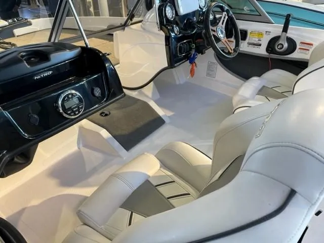 Slide: The Image of Interior of 2019 Nitro Z19 Sport boat with white seating and modern dashboard. - 7