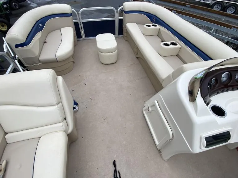 Slide: The Image of 2011 Bennington 22SLi pontoon boat interior with beige seating and helm. - 3