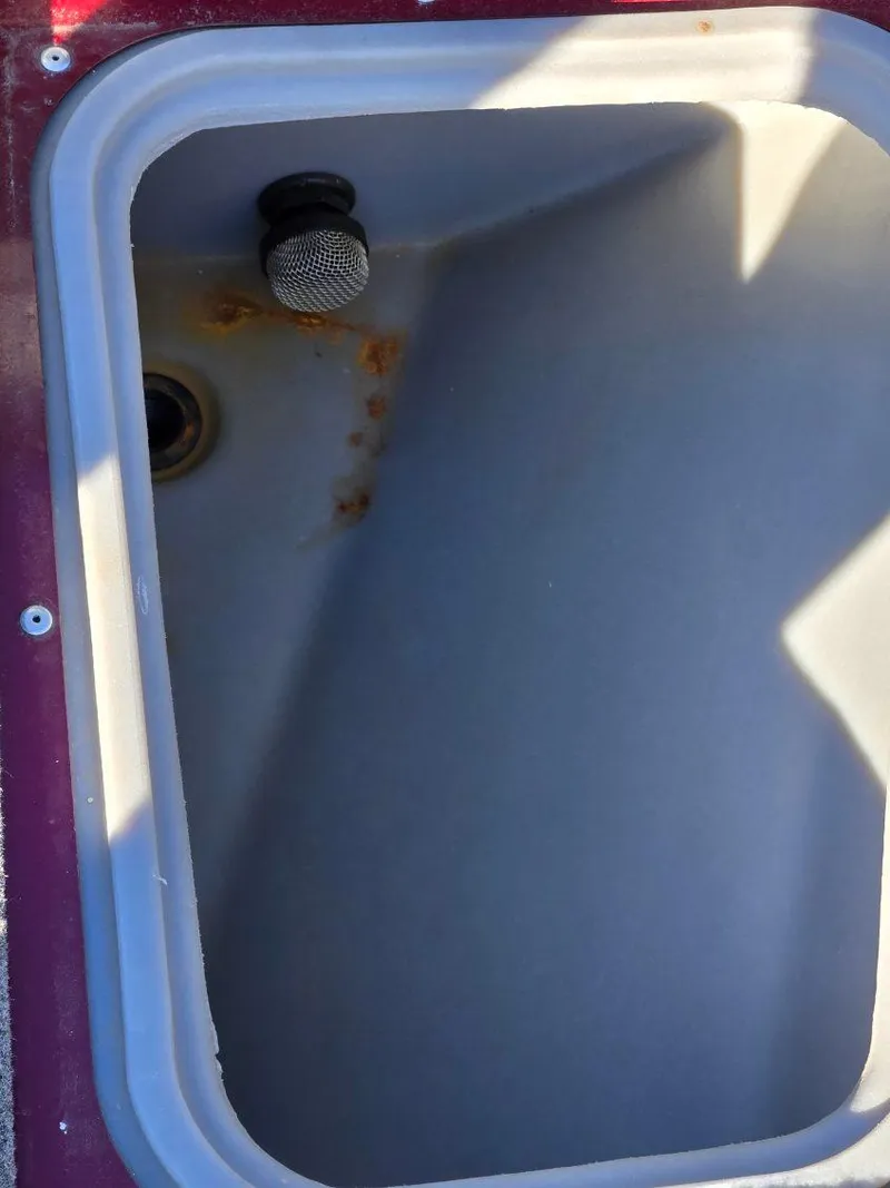 Slide: The Image of 2018 Tracker Pro Guide V-175 WT boat compartment with drain and plug. - 10