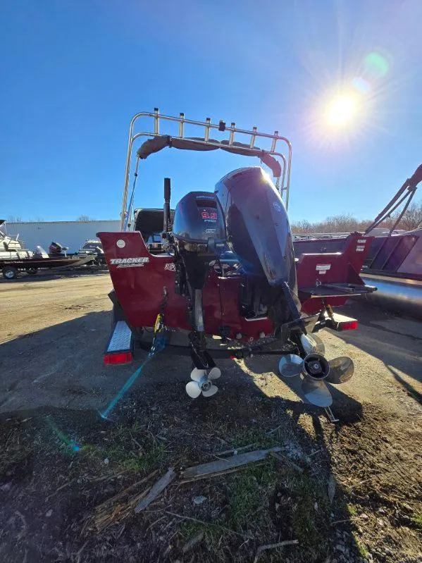 Slide: The Image of 2018 Tracker Pro Guide V-175 WT boat with outboard motor in sunny outdoor setting. - 22