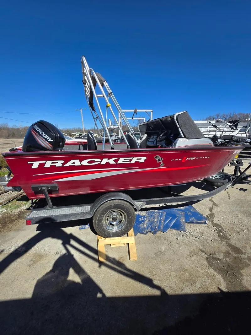 Slide: The Image of 2018 Tracker Pro Guide V-175 WT boat, red, on trailer, clear blue sky background. - 7