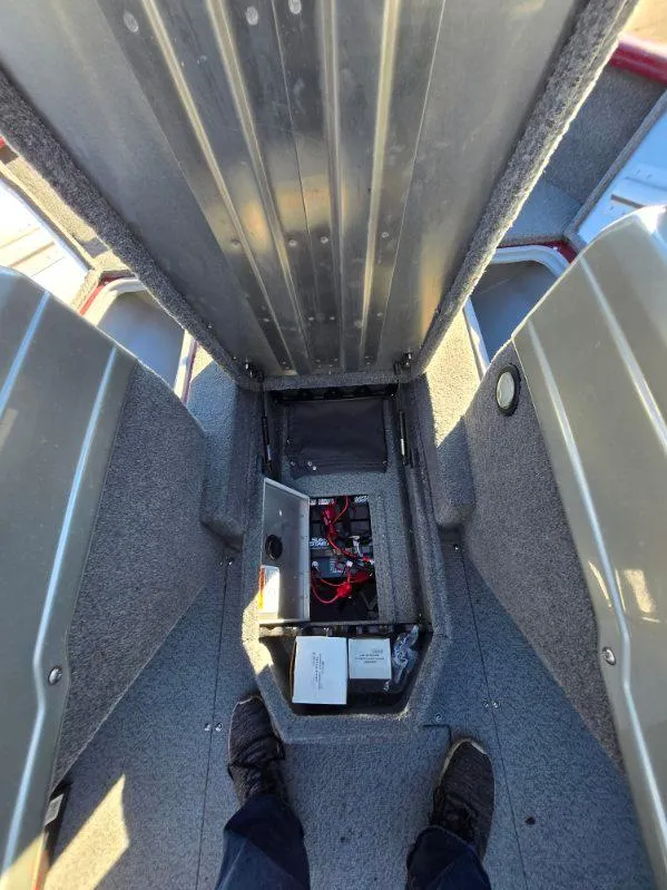 Slide: The Image of 2018 Tracker Pro Guide V-175 WT boat interior showing storage compartment and battery. - 9
