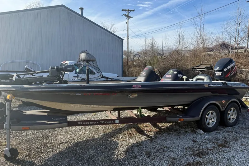 Slide: The Image of 2003 Ranger 521DVX boat on trailer, parked outdoors near a building. - 3