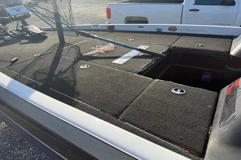 Slide: The Image of 2003 Ranger 521DVX boat deck with storage compartments and fishing gear. - 7