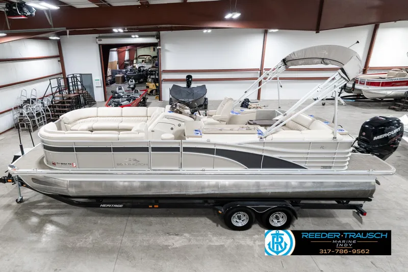 Slide: The Image of 2014 Bennington 2250 RCB pontoon boat in showroom, side view, on trailer. - 1