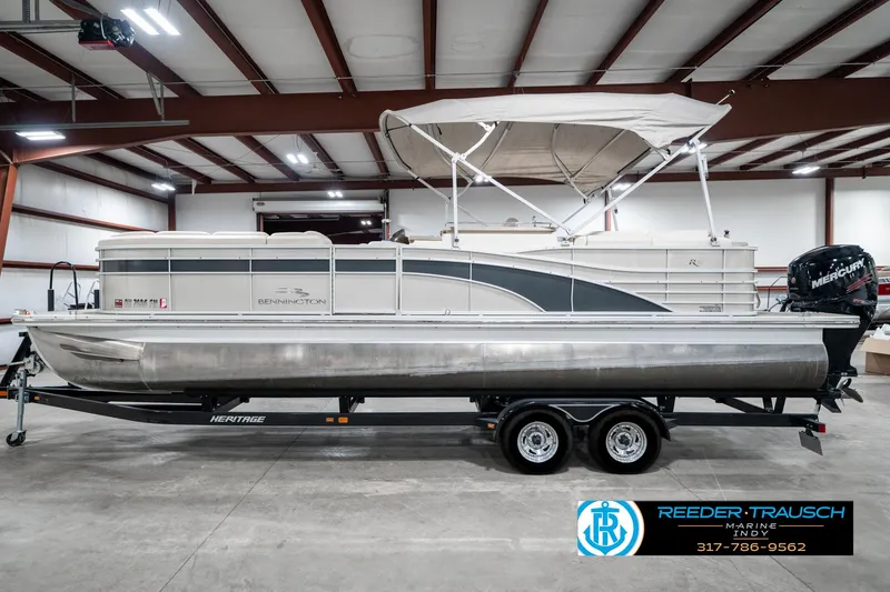 Slide: The Image of 2014 Bennington 2250 RCB pontoon boat on trailer in indoor storage facility. - 11