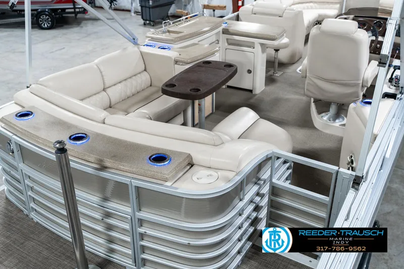 Slide: The Image of 2014 Bennington 2250 RCB pontoon boat interior with beige seating and table. - 14