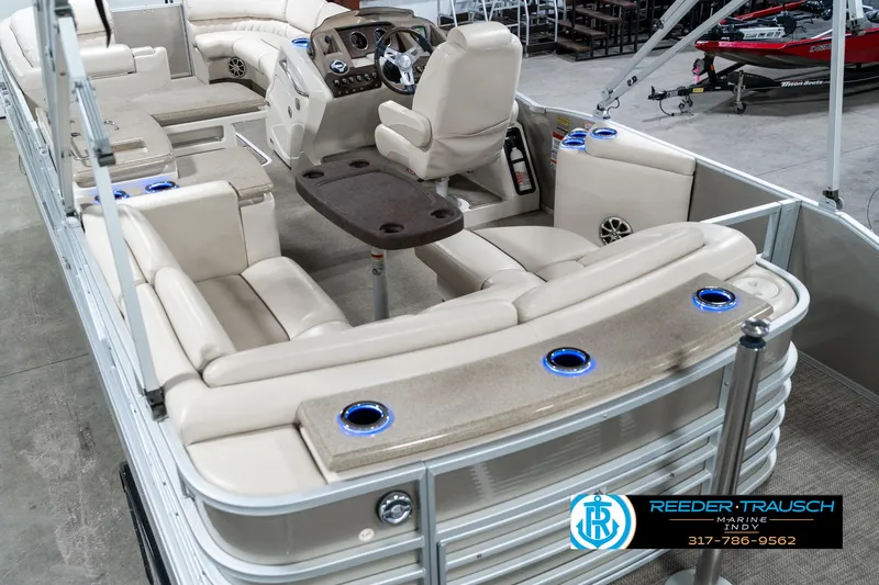 Slide: The Image of 2014 Bennington 2250 RCB pontoon boat interior with beige seating and control console. - 15