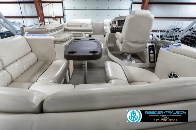 Slide: The Image of 2014 Bennington 2250 RCB boat interior with beige seating and a central table. - 19