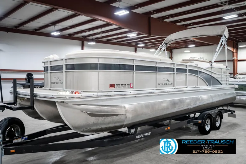 Slide: The Image of 2014 Bennington 2250 RCB pontoon boat on trailer in indoor storage facility. - 2