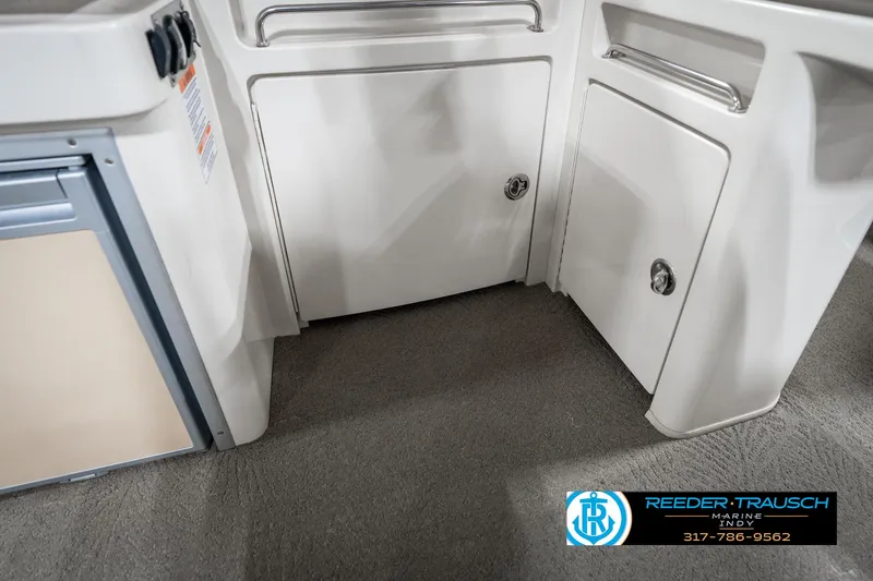 Slide: The Image of Interior view of a 2014 Bennington 2250 RCB boat, featuring storage compartments. - 25