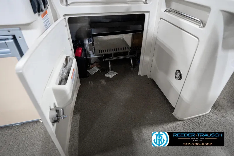 Slide: The Image of Open storage compartment in 2014 Bennington 2250 RCB boat interior. - 26