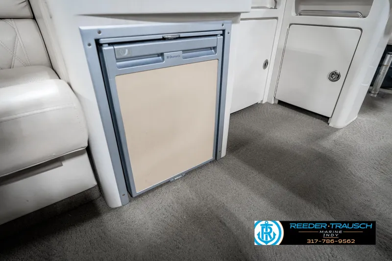 Slide: The Image of 2014 Bennington 2250 RCB interior with built-in mini fridge and seating. - 28