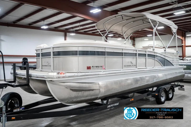Slide: The Image of 2014 Bennington 2250 RCB pontoon boat on trailer in indoor storage facility. - 3