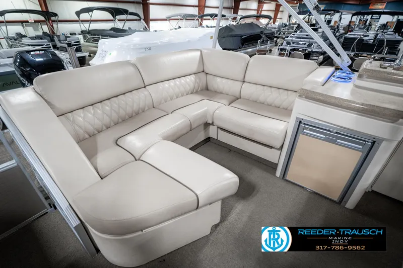 Slide: The Image of 2014 Bennington 2250 RCB boat interior with beige seating in showroom. - 31