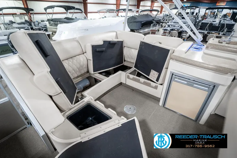 Slide: The Image of 2014 Bennington 2250 RCB boat interior with open storage compartments in a showroom. - 32