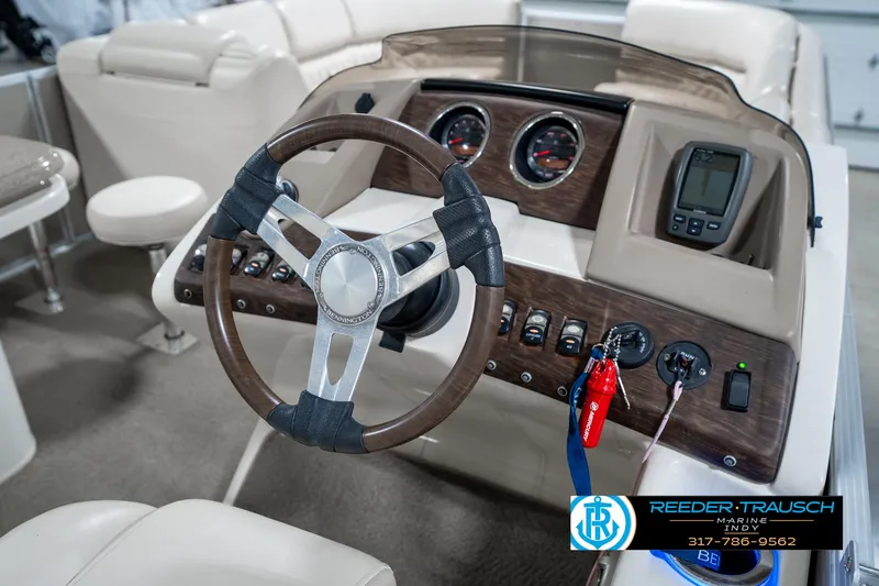 Slide: The Image of 2014 Bennington 2250 RCB boat dashboard with steering wheel and control panel. - 33